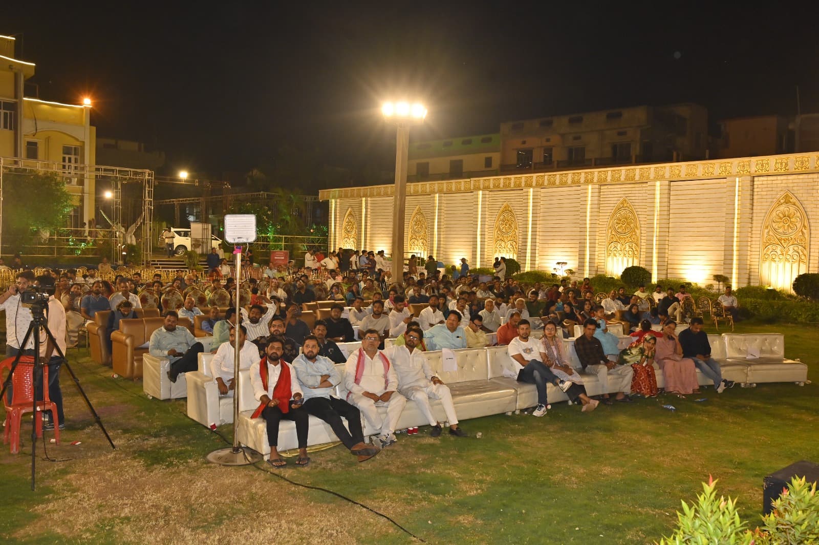 Guests seated outdoors during a cultural evening at Adarsh Vatika