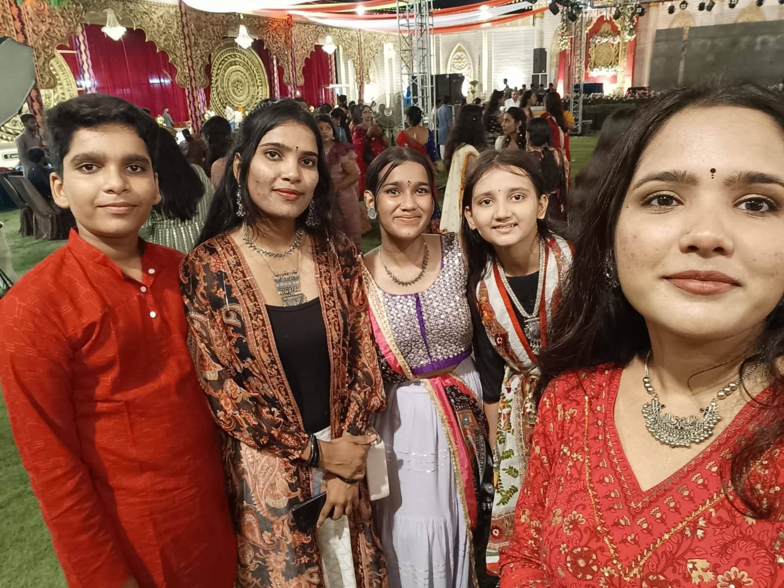 Guests taking a group photograph during a dandiya celebration