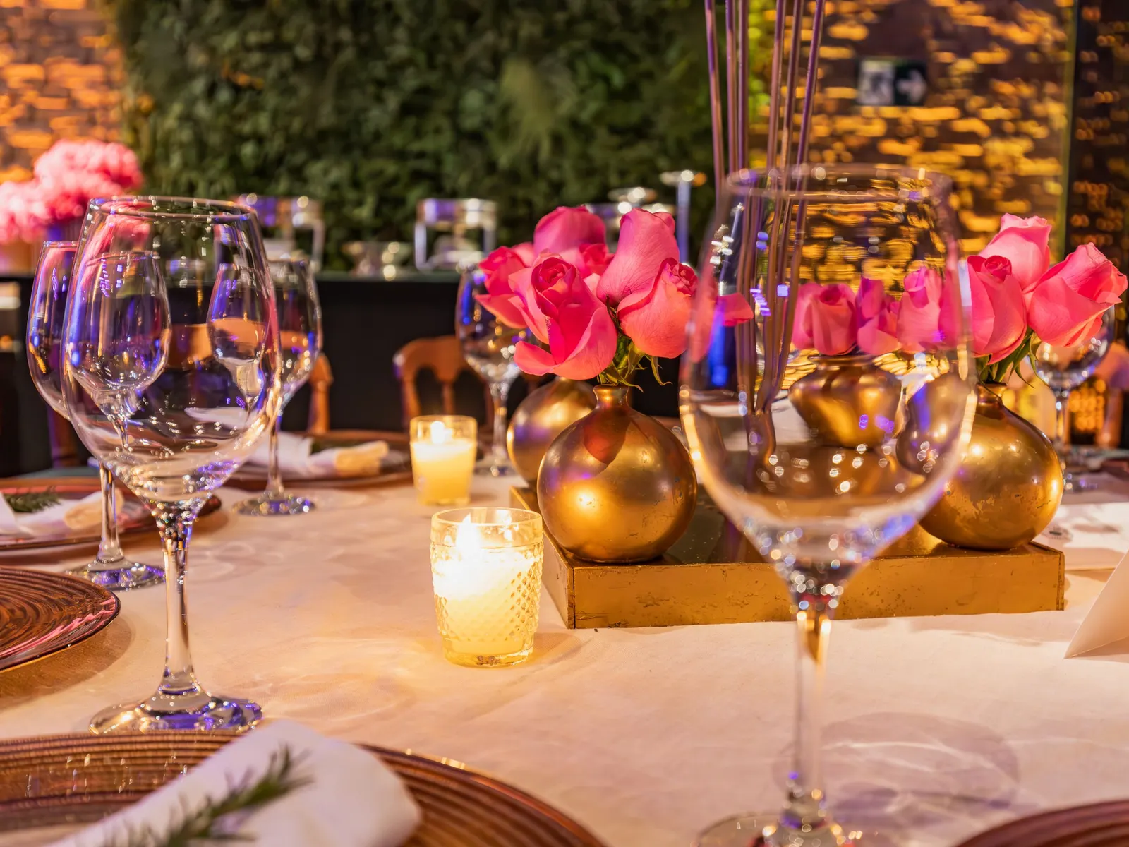 Temporary concept image of celebration table with candles, roses and glassware at night; not property photography.