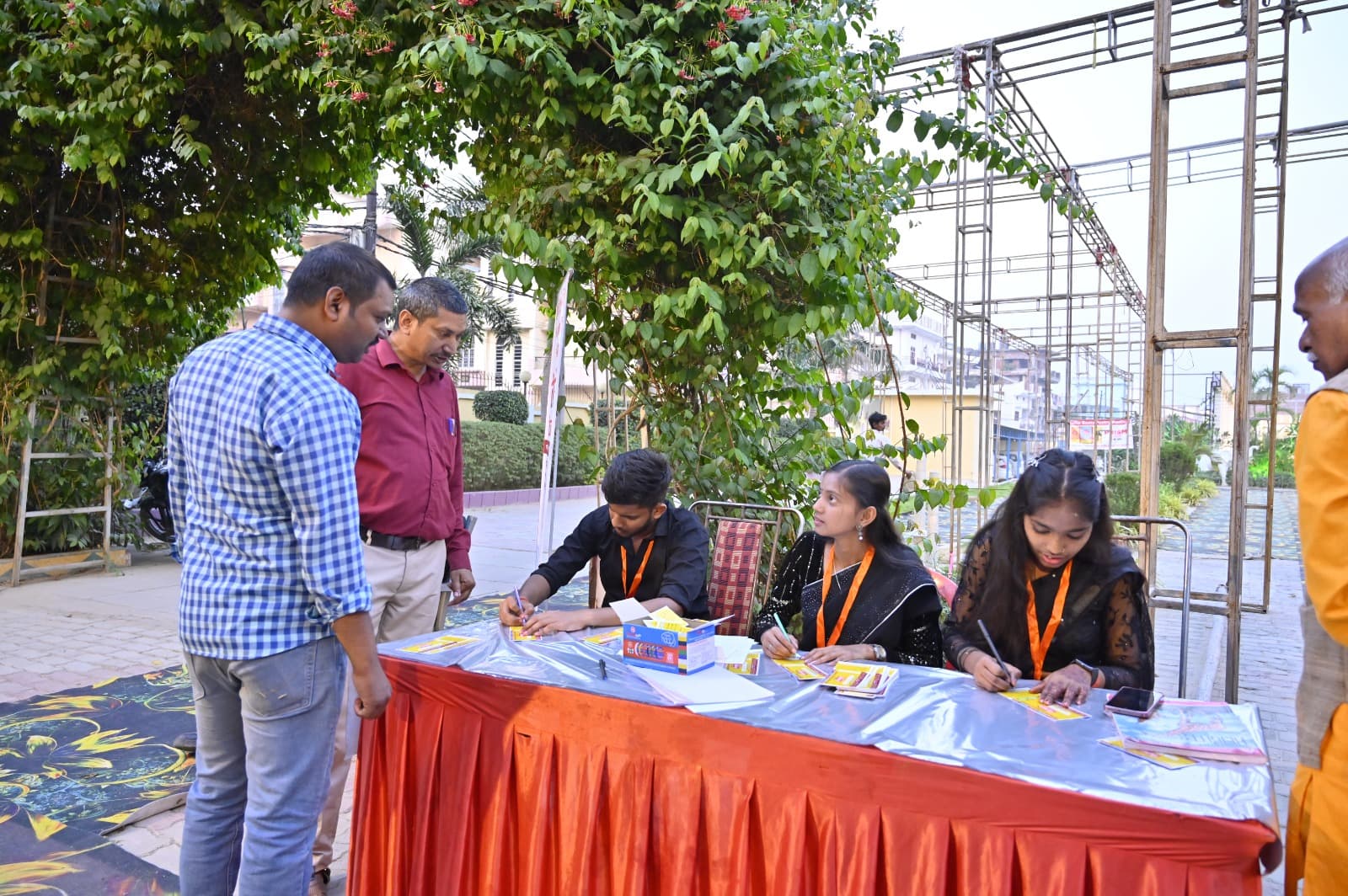 Guests checking in at the outdoor event registration desk at Adarsh Vatika