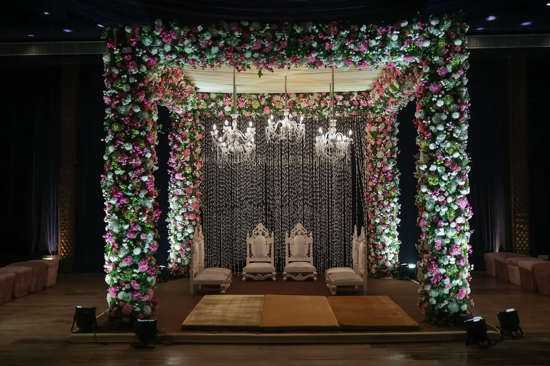Temporary concept image of floral mandap with chandeliers prepared for a wedding ceremony; not property photography.