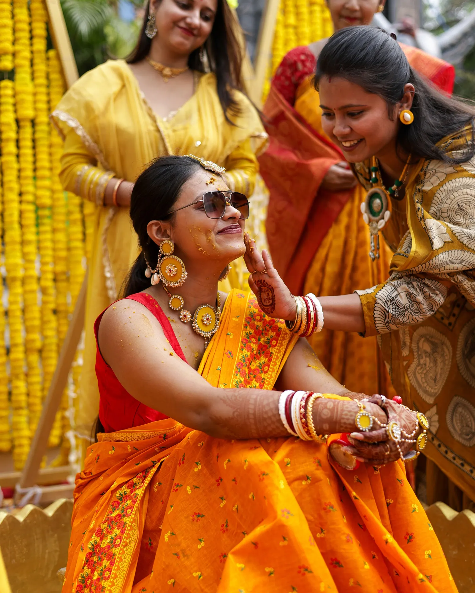Temporary concept image of women in yellow celebrating a haldi morning together; not property photography.