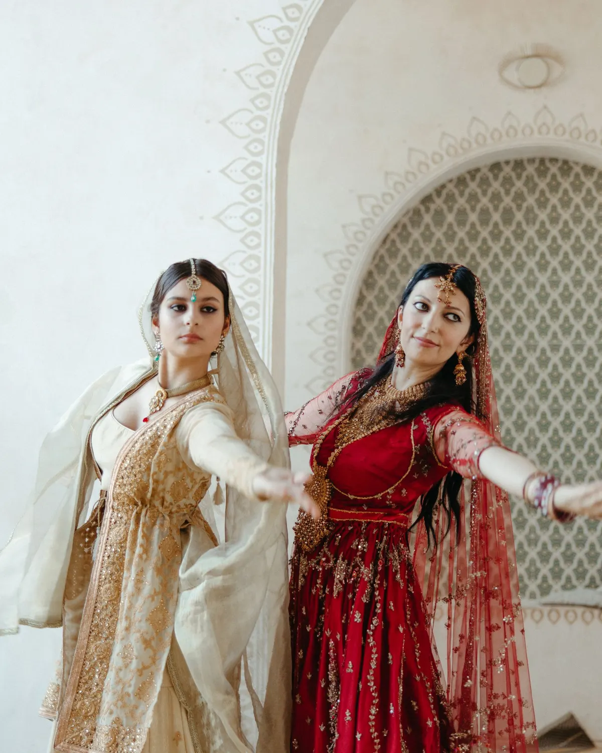 Temporary concept image of two women in traditional dress dancing together at an evening function; not property photography.