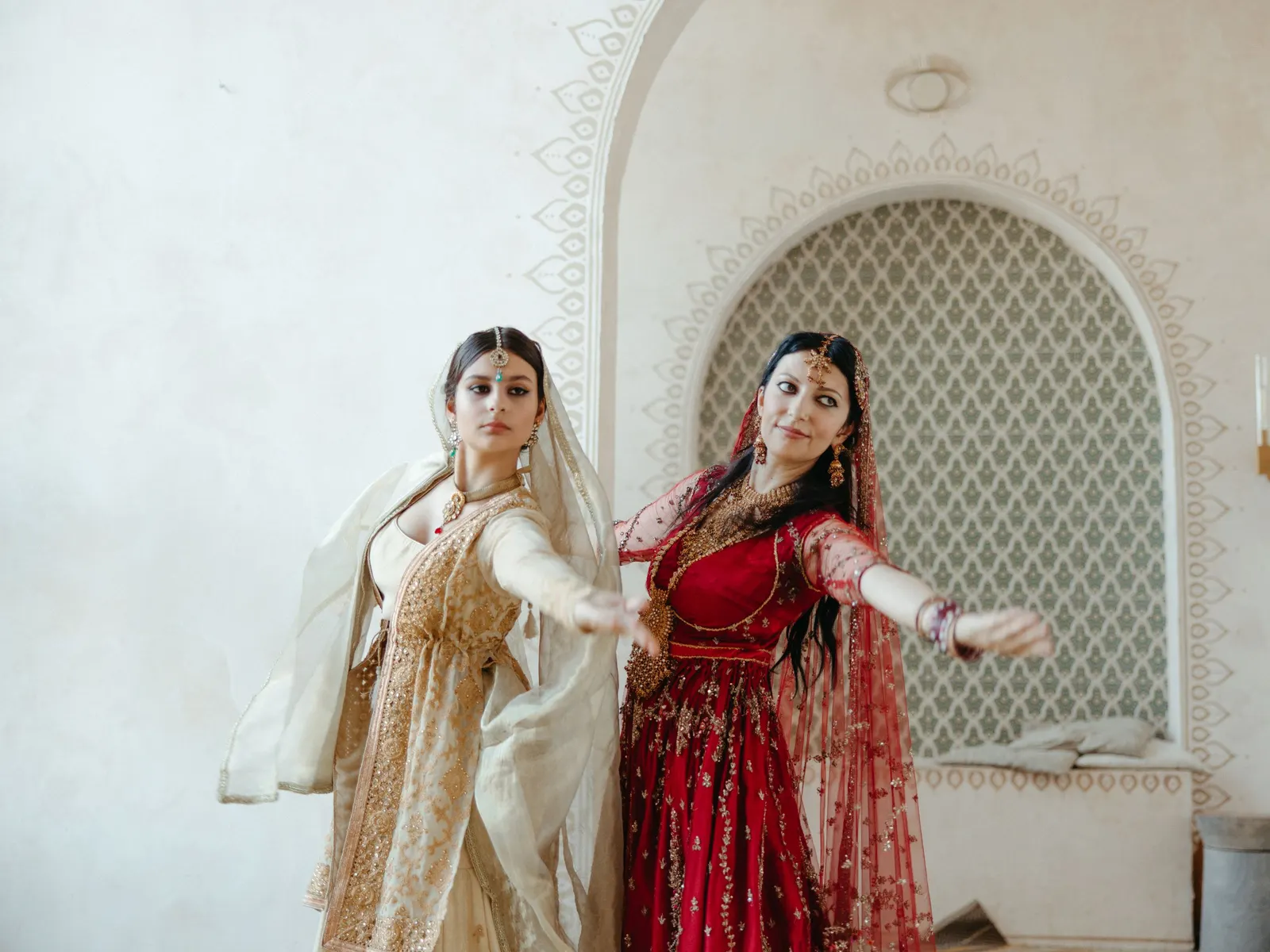 Temporary concept image of two women in traditional dress dancing together at an evening function; not property photography.