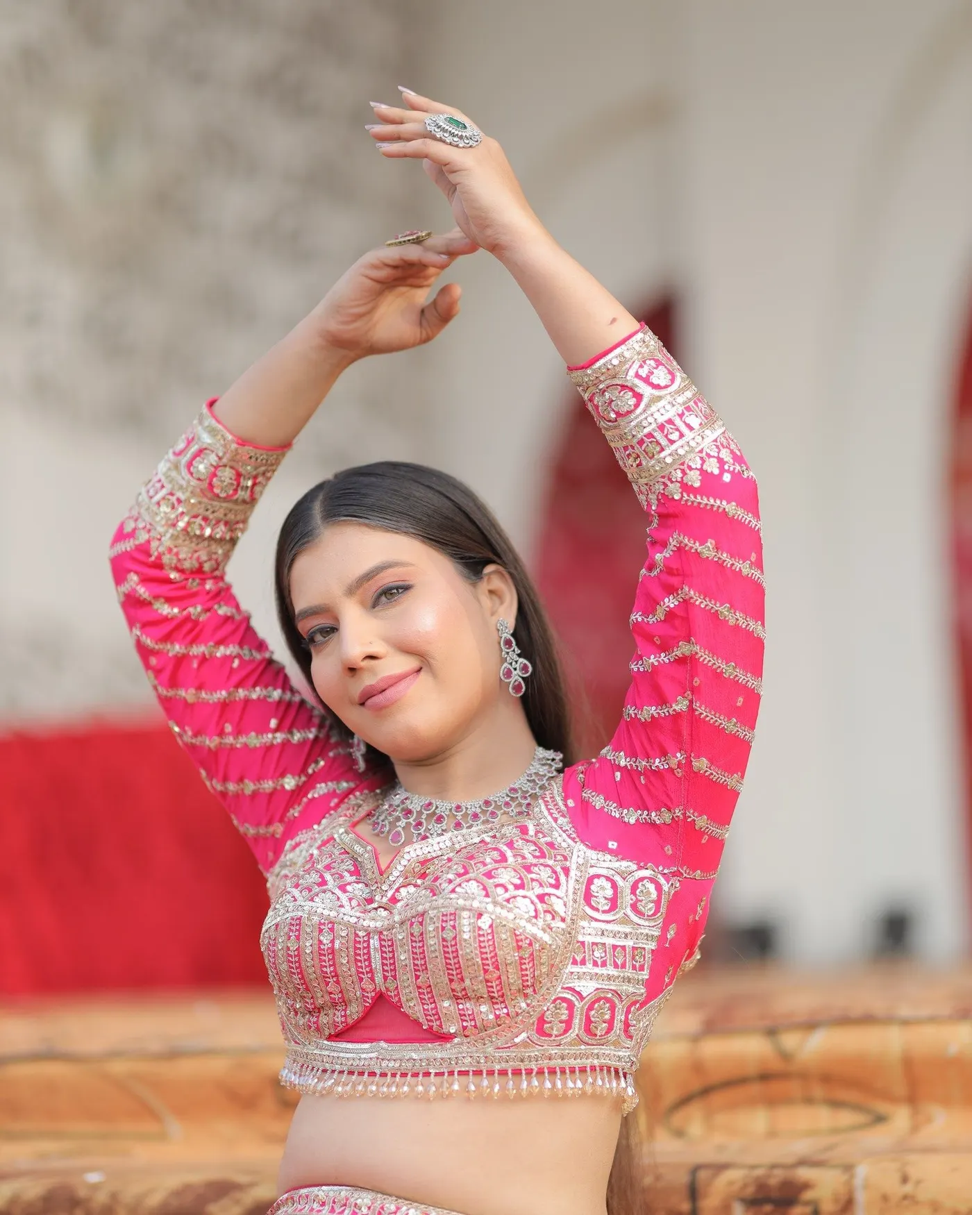 Temporary concept image of a dancer in a pink lehenga mid-performance; not property photography.