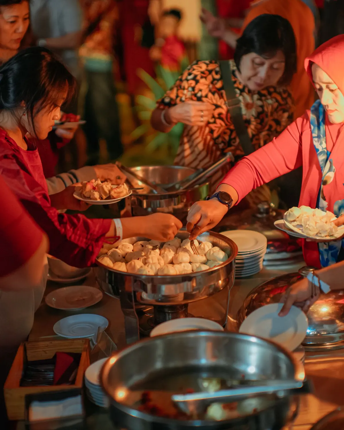 Temporary concept image of family and friends gathered around a warm candlelit dinner buffet; not property photography.