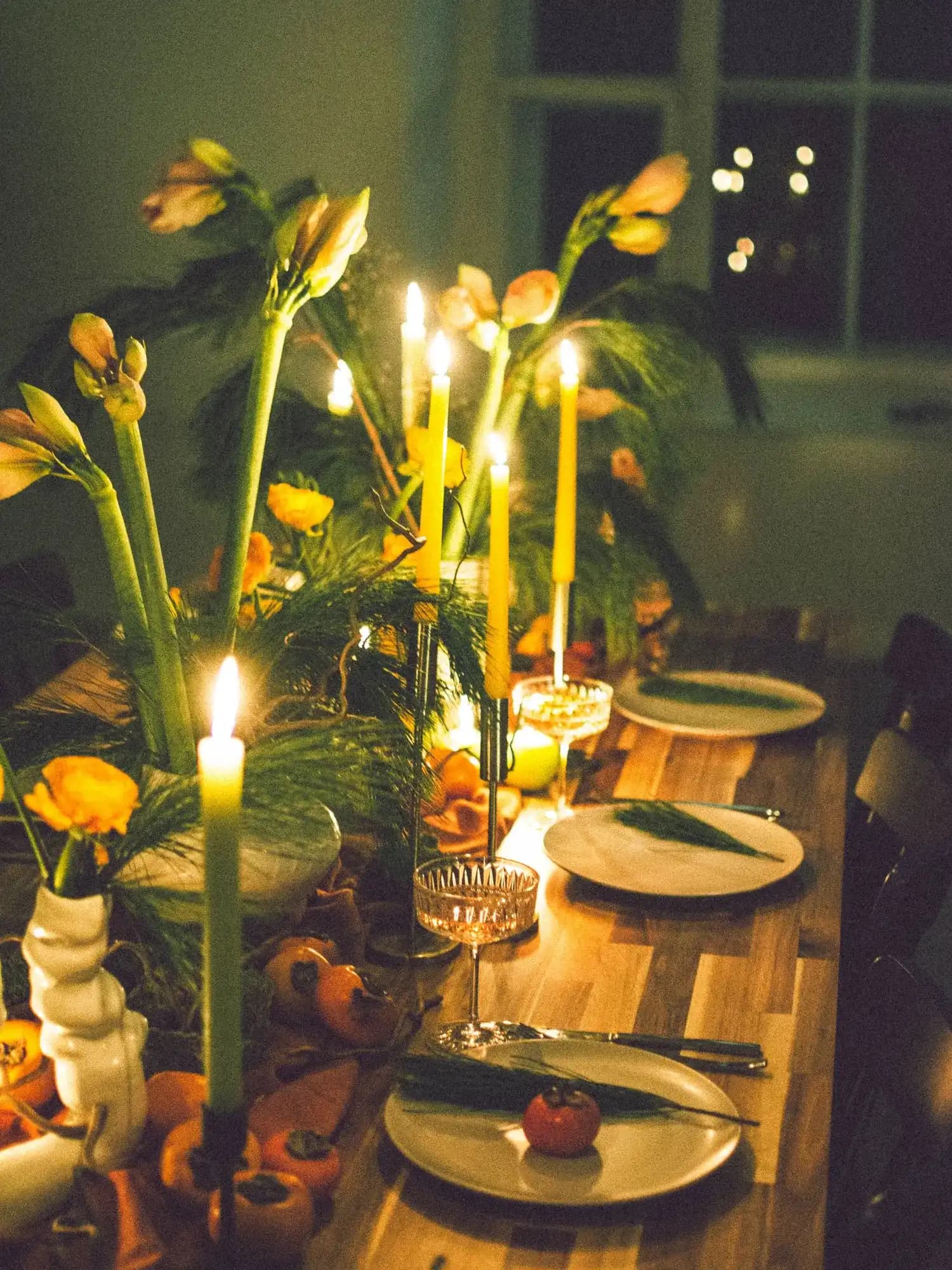 Temporary concept image of candlelit dinner table with flowers and glassware; not property photography.