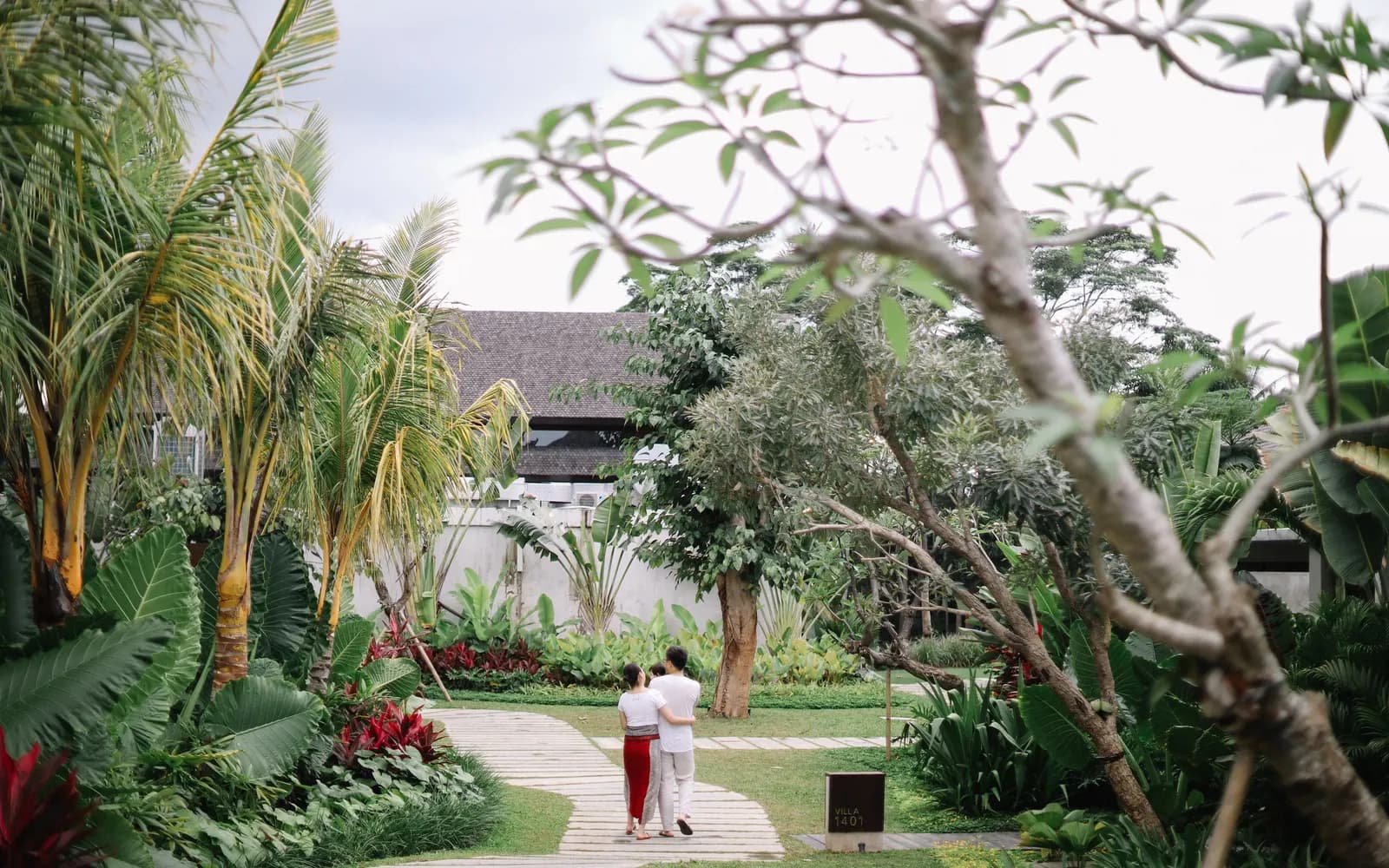 Temporary concept image of a couple walking hand in hand through a lush garden path; not property photography.