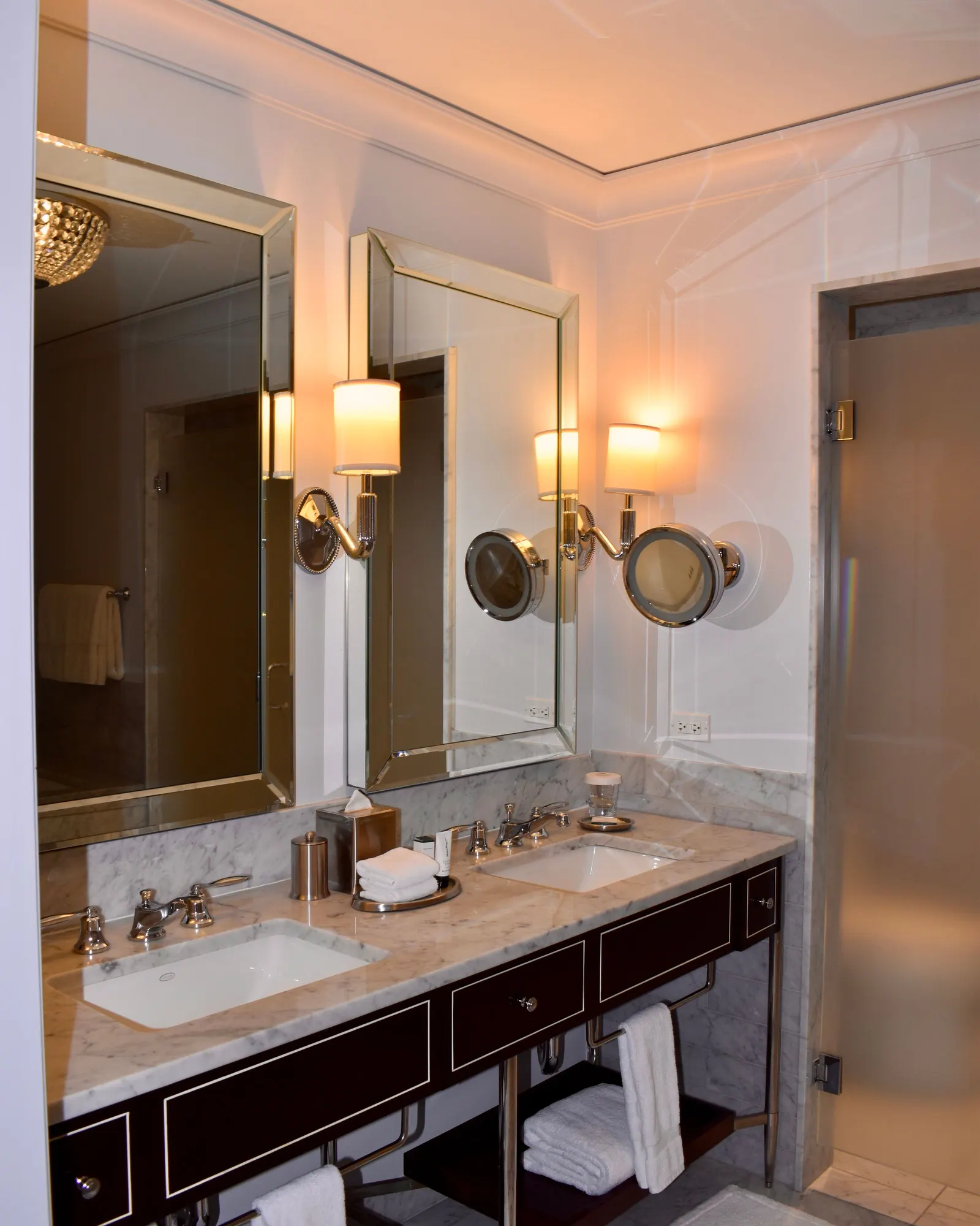 Temporary concept image of marble washbasin counter with soft hotel lighting; not property photography.